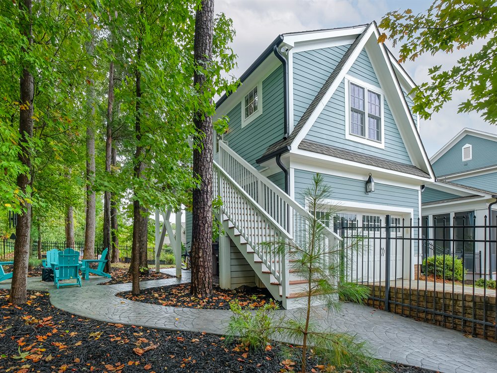 The finished guest suite from the patio side, with its exterior stair and window gable