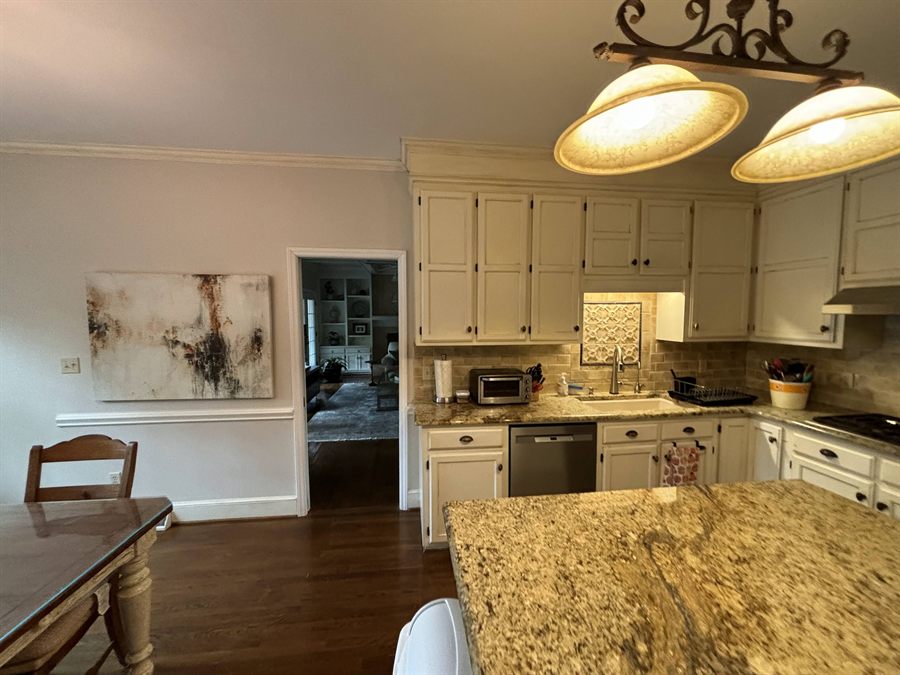 Providence Plantation kitchen before renovation, with cream cabinets and a granite island