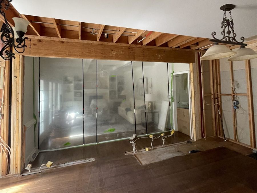 The same kitchen during demolition, with the wall opened to the framing