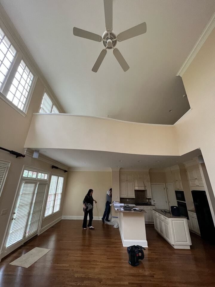 SouthPark two-story great room before renovation, with an open kitchen at the far end