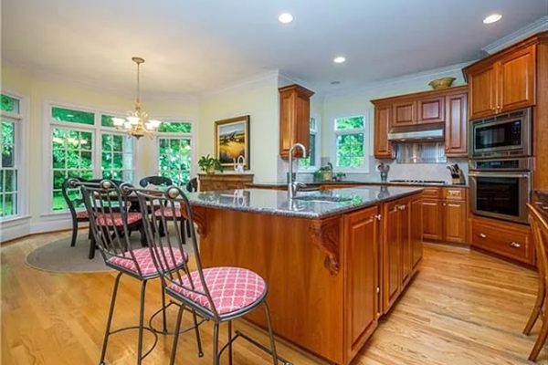 Waxhaw kitchen before renovation, with cherry cabinets and a granite island