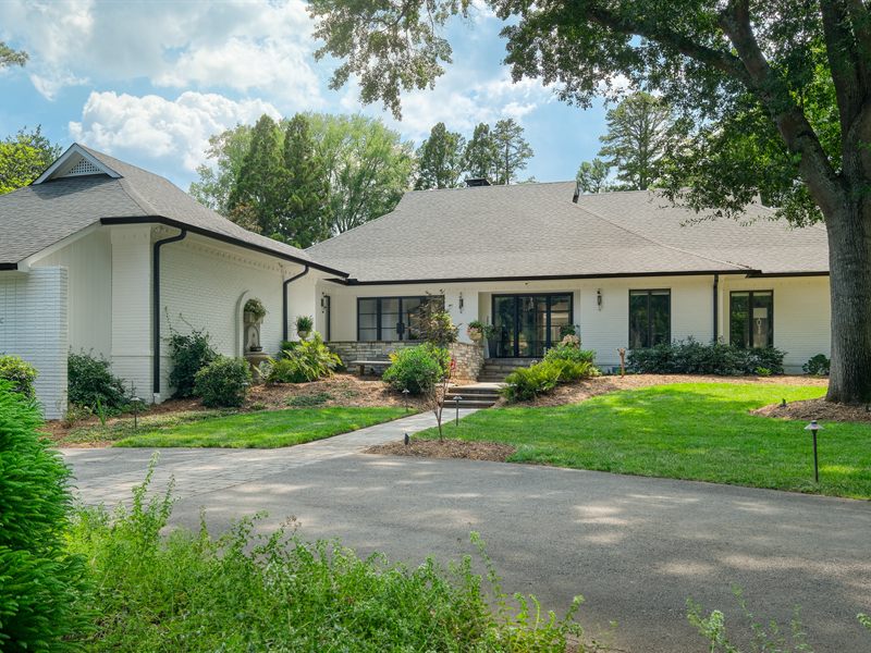 Front of a white-brick custom home in Pellyn Wood, Charlotte, by Revival Construction