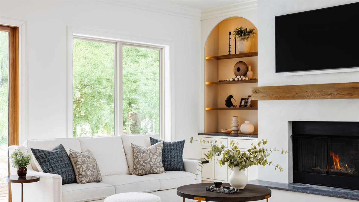 Living room of a Waxhaw whole-home renovation by Revival Construction, with an arched built-in and a white oak mantel