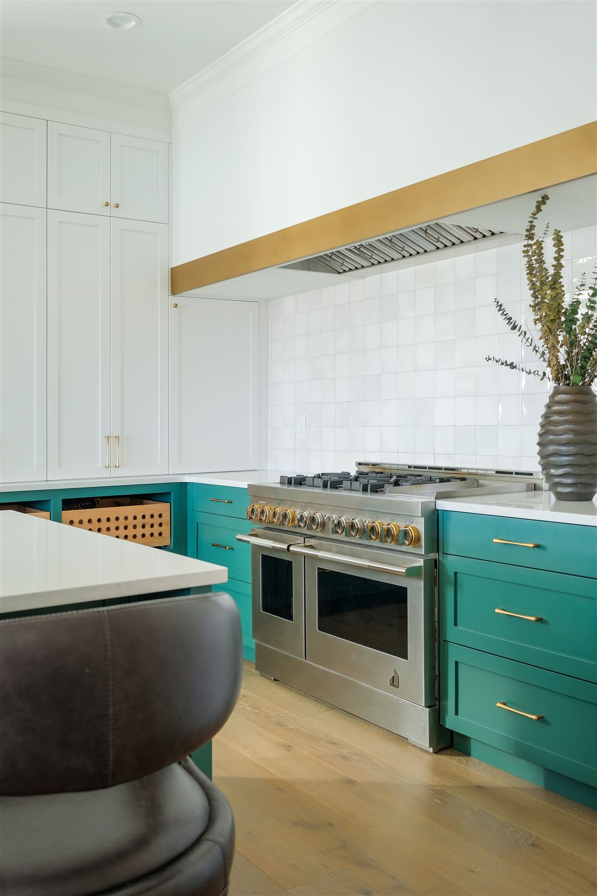 Teal custom cabinetry with brass-banded vent hood and white Zellige tile backsplash, Lake Wylie kitchen renovation