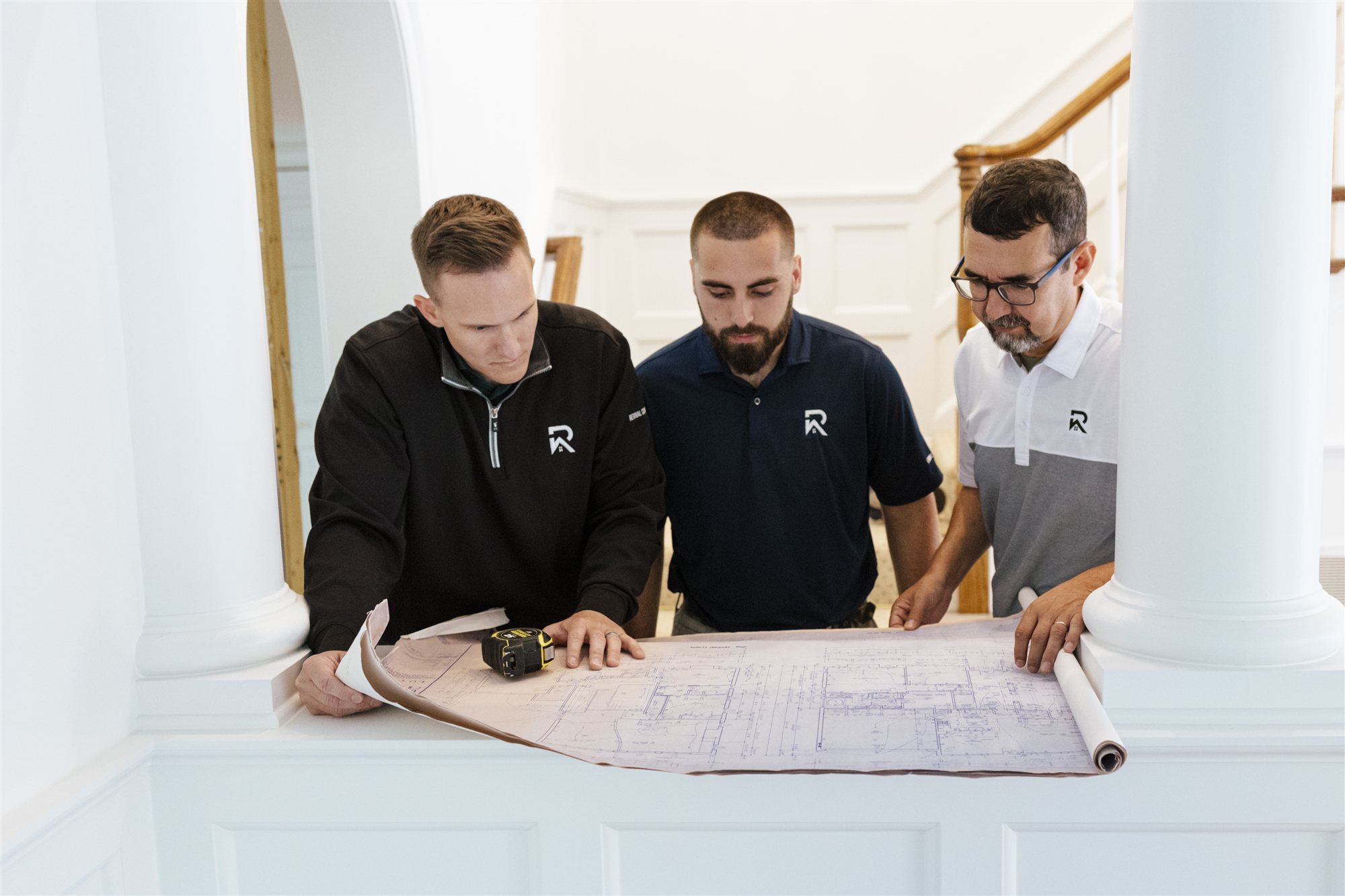 The Revival Construction team reviewing architectural plans during pre-construction