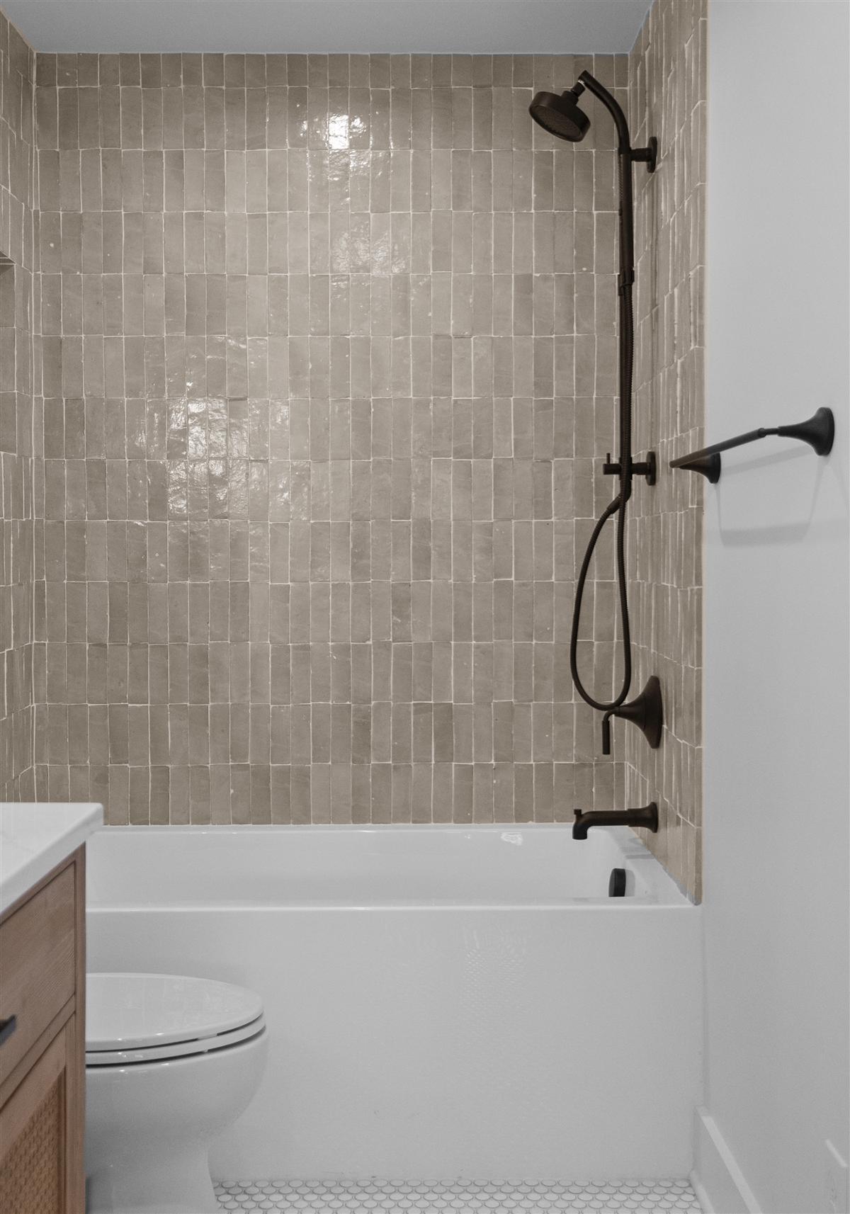 Tub shower in handmade zellige tile with black fixtures, Charlotte ADU