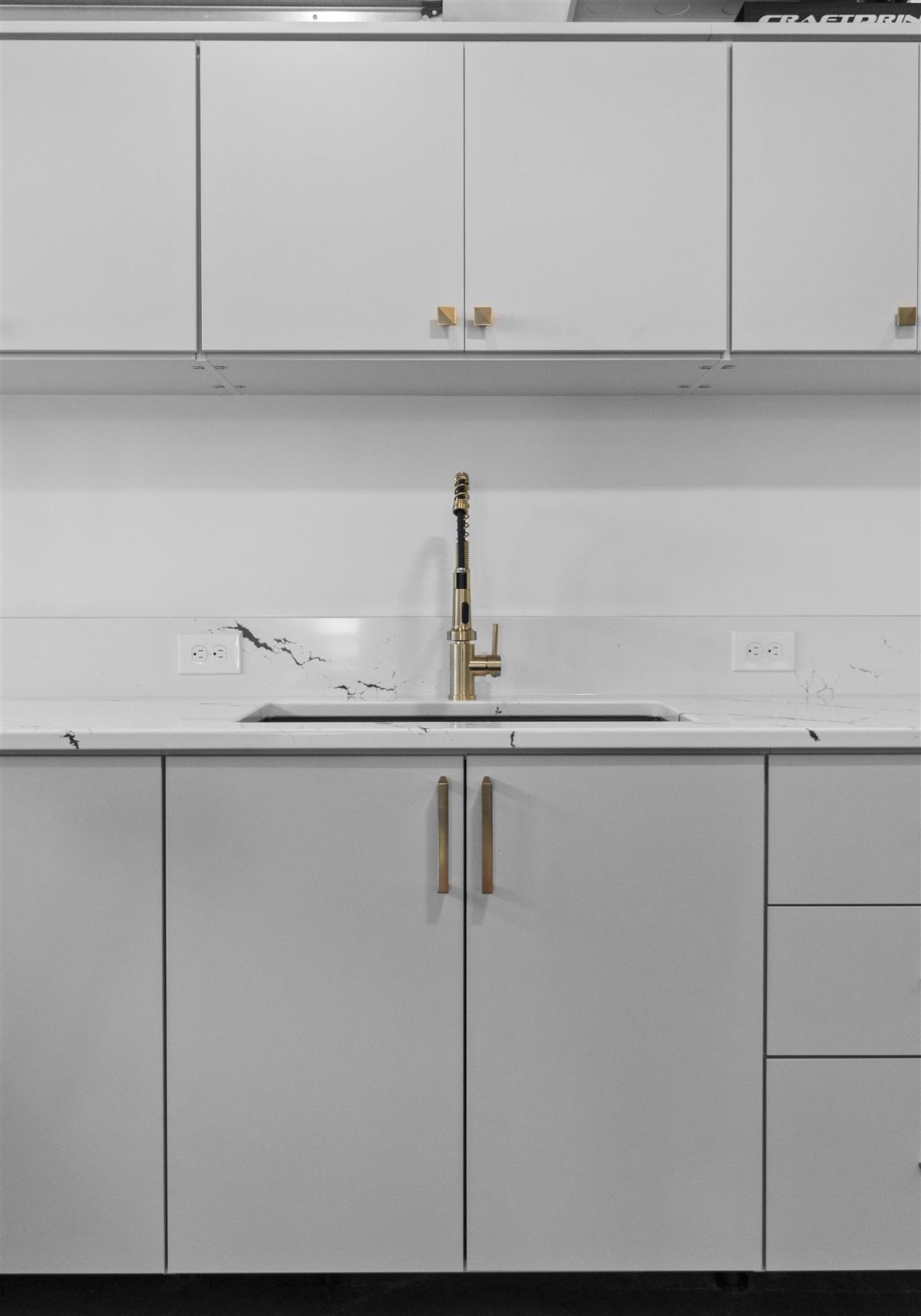 Kitchenette with white cabinets and a brass faucet, Charlotte ADU