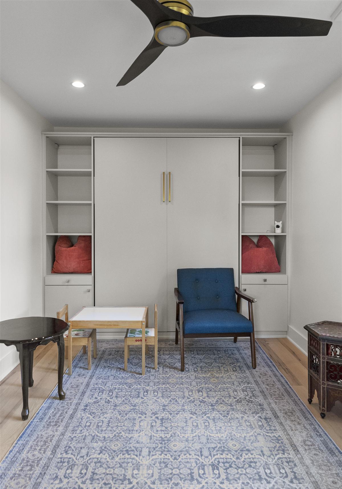 Sitting area with built-in shelves and a ceiling fan, Charlotte ADU