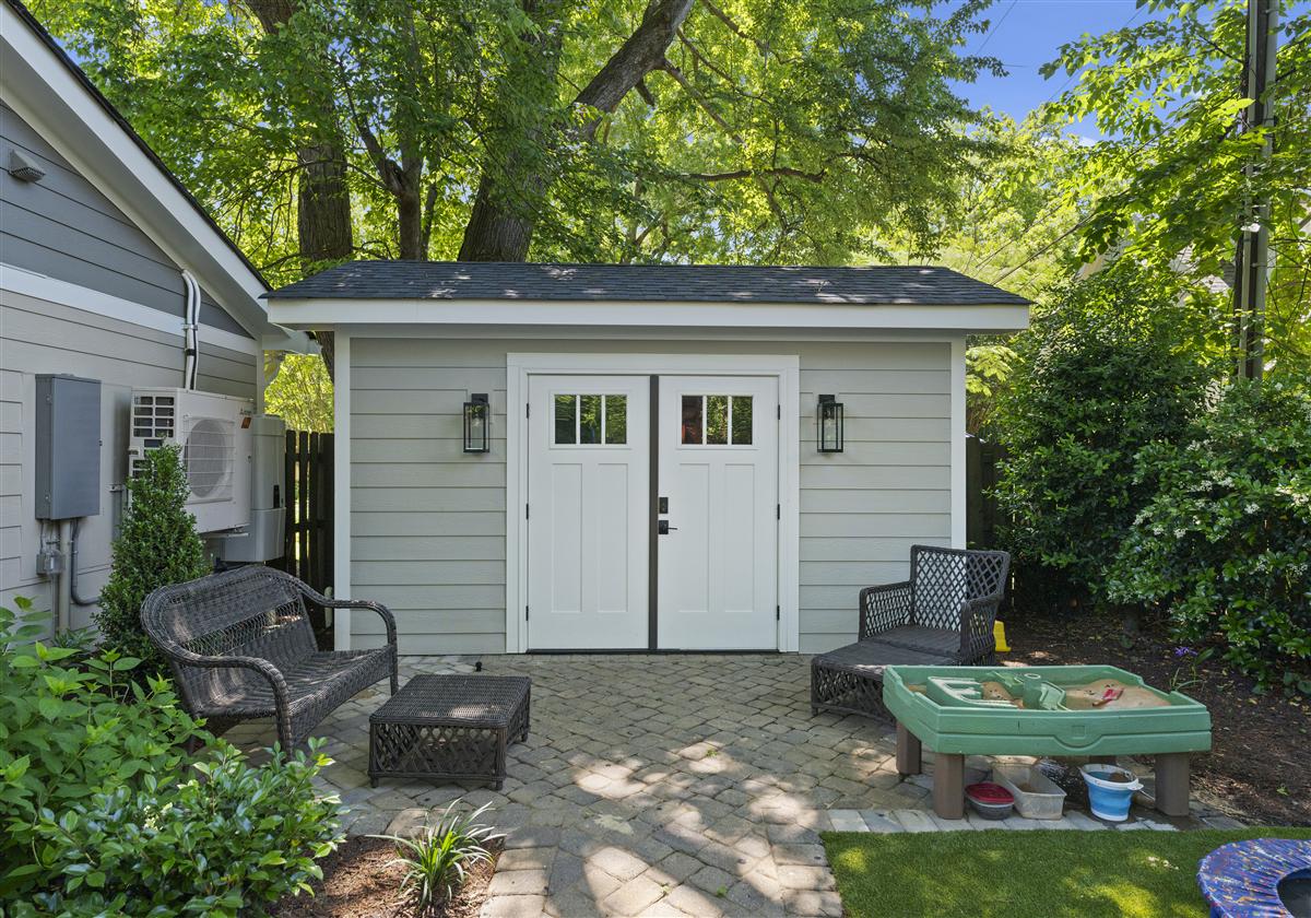 Guest studio exterior with French doors and a patio seating area, Charlotte ADU