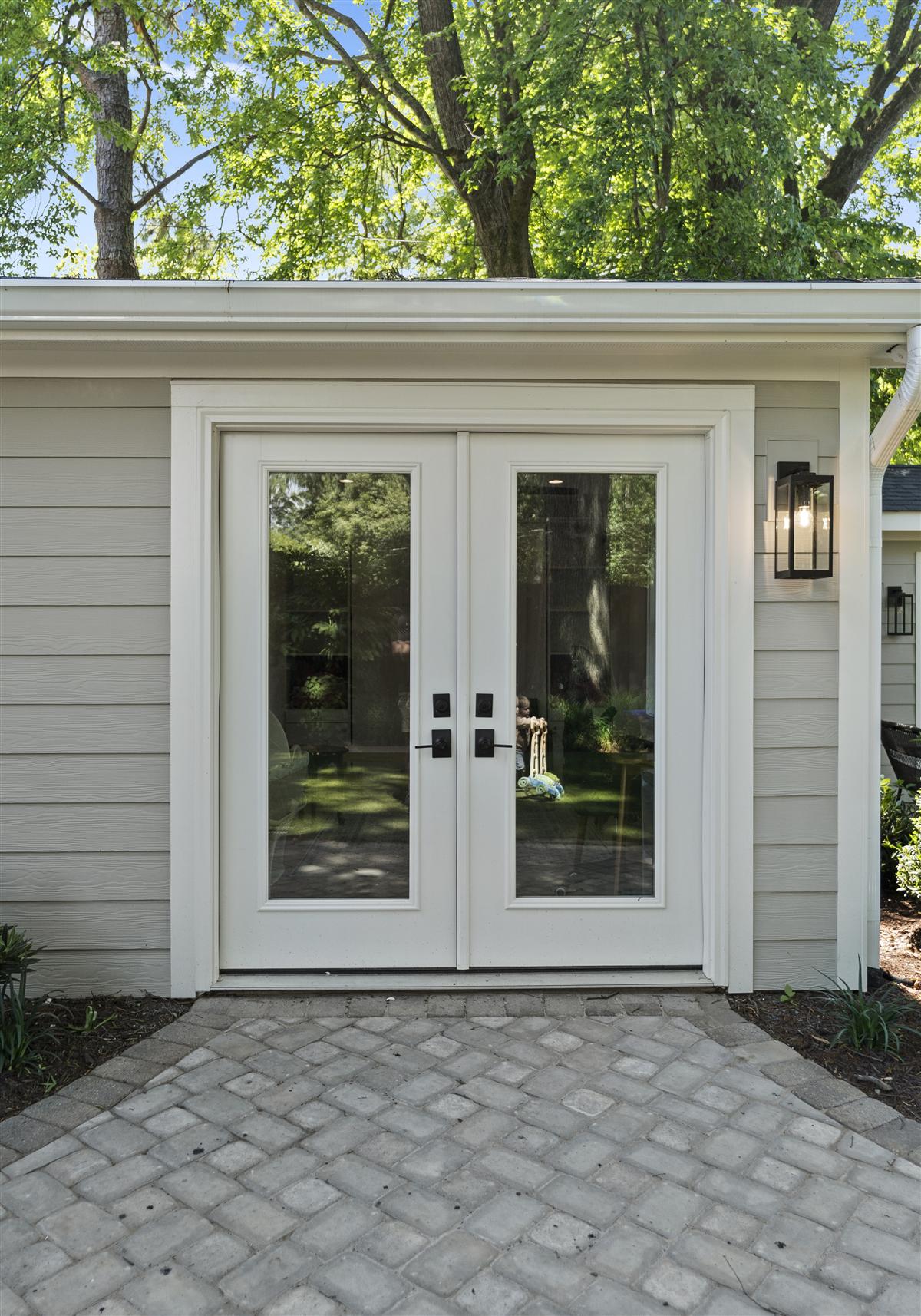 Glass French doors on a paver patio, Charlotte ADU