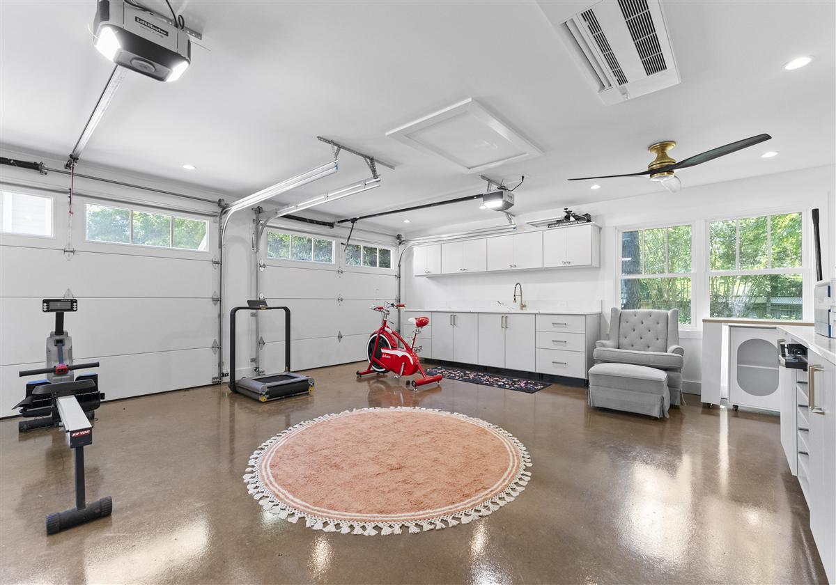 Converted garage home gym with a polished concrete floor and ceiling fans, Charlotte ADU