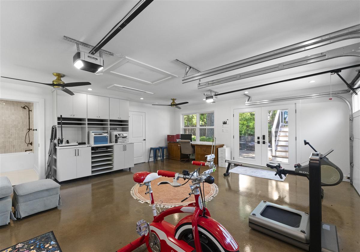 Home gym with a work area and garage-door windows, Charlotte ADU