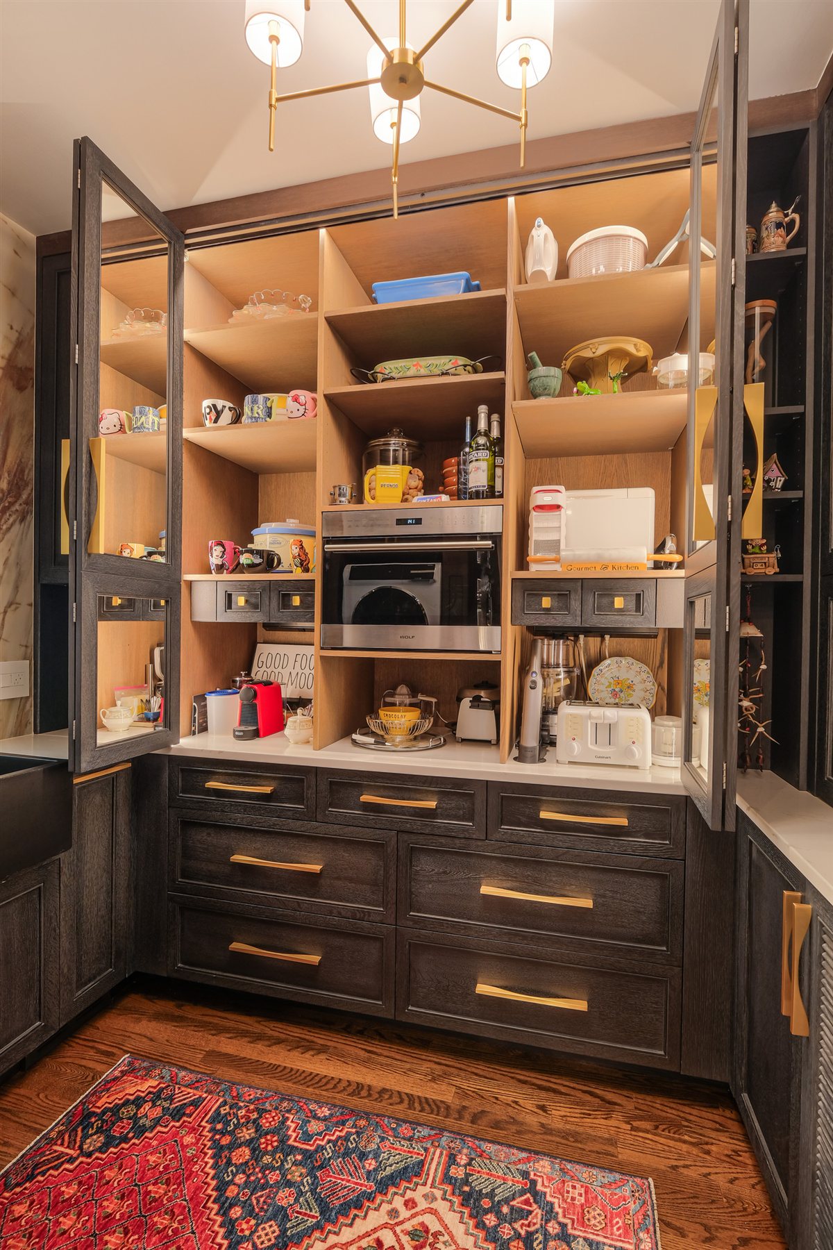 Pantry cabinet open to lit wood shelving, Charlotte chef's kitchen