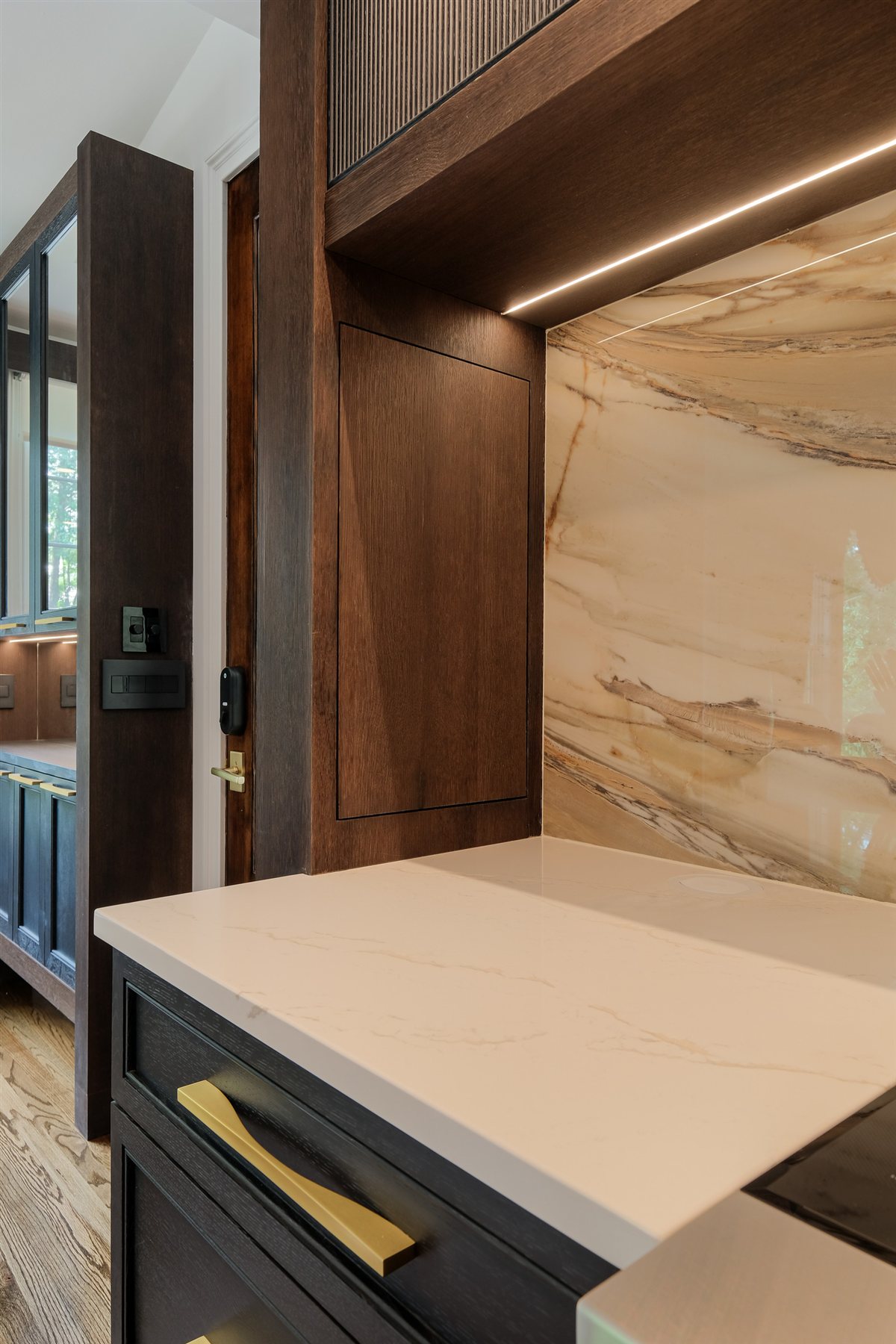Porcelain slab backsplash with a quartz countertop and brass pull, Charlotte chef's kitchen