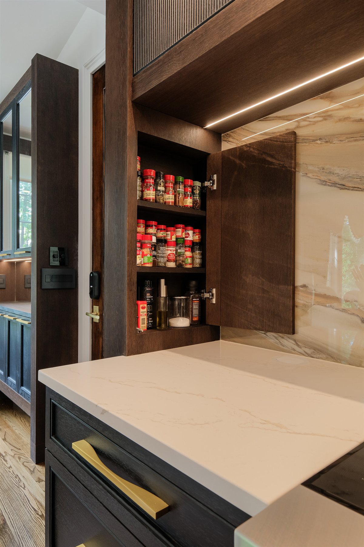 Hidden spice pull-out beside the porcelain slab, Charlotte chef's kitchen