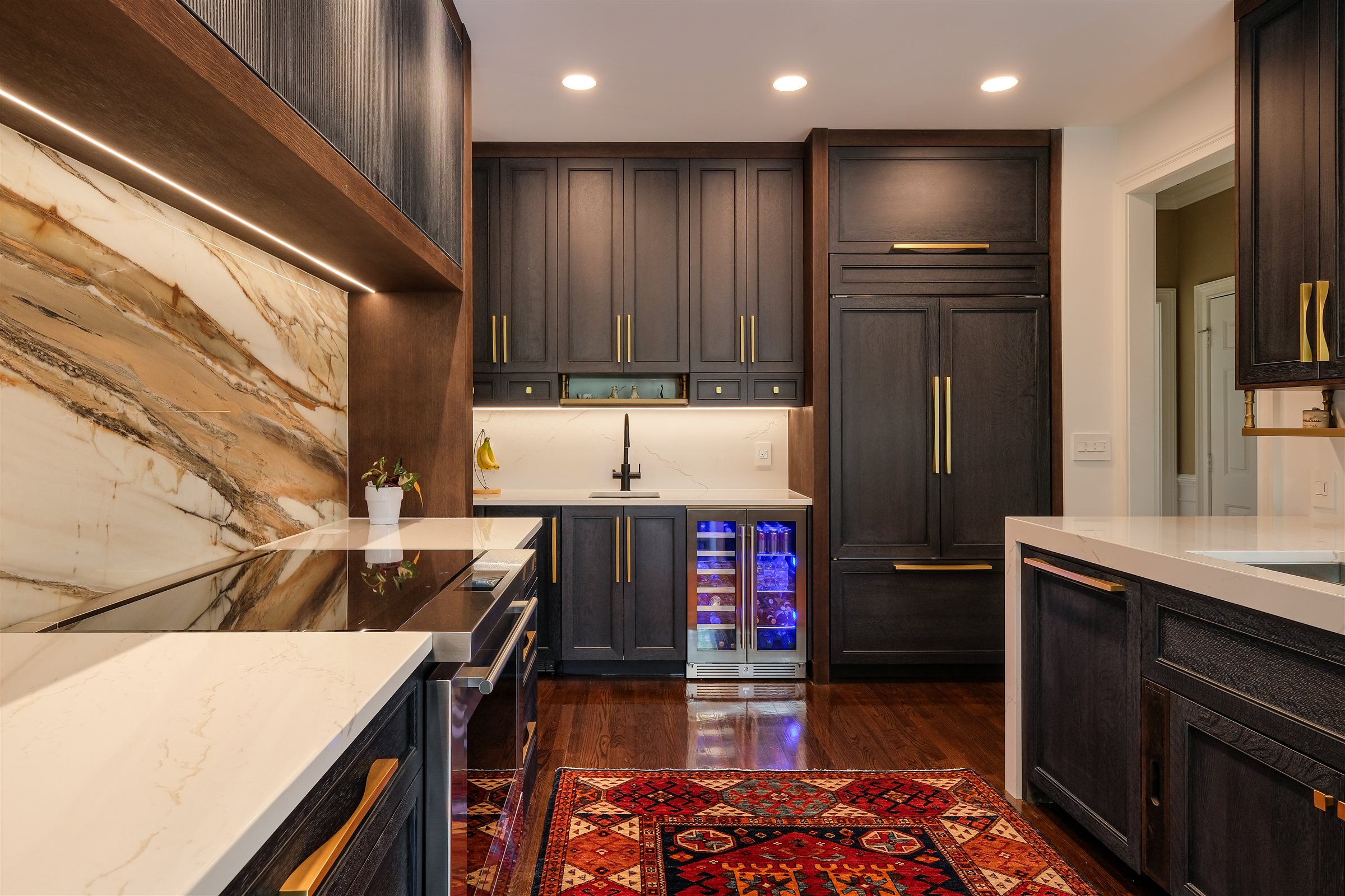Charlotte chef's kitchen by Revival Construction: dark stained cabinetry and a jumbo porcelain slab backsplash