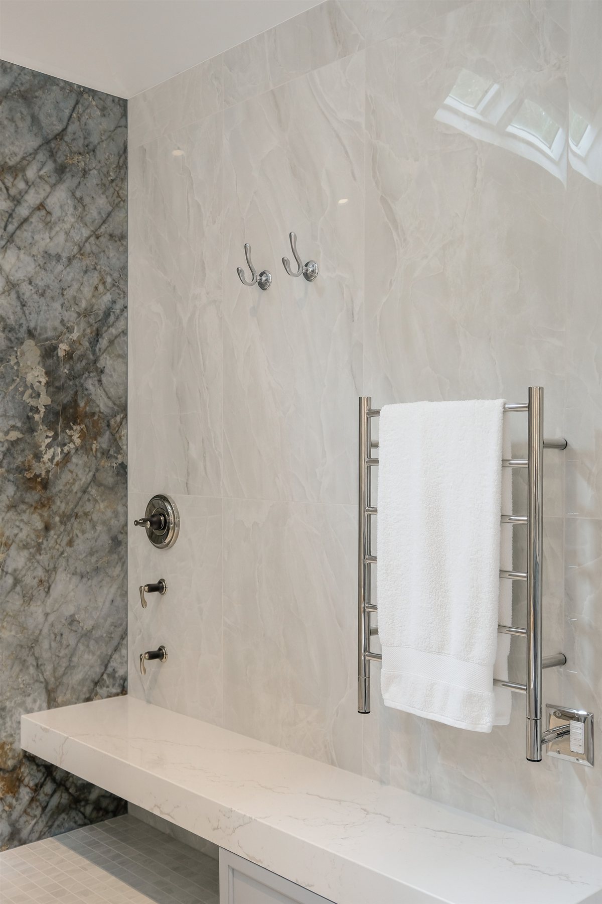 Heated towel bar and floating quartz-wrapped shower bench, Charlotte spa bath