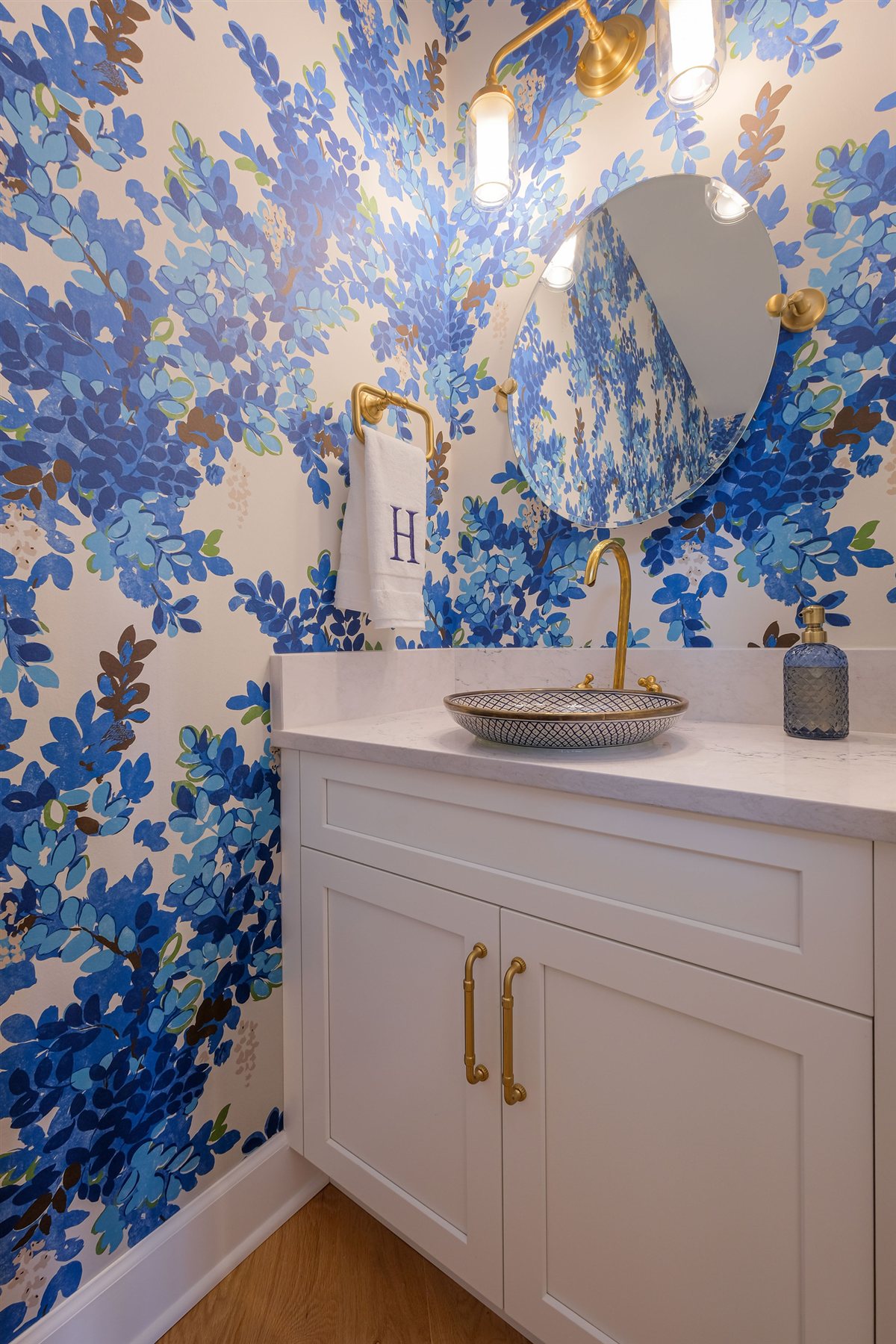Powder room with bold blue floral wallpaper and a white vanity, Peninsula townhouse renovation in Cornelius