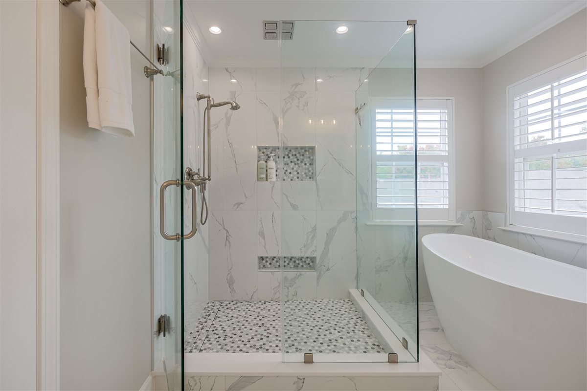 Glass shower beside a freestanding tub, Peninsula townhouse renovation