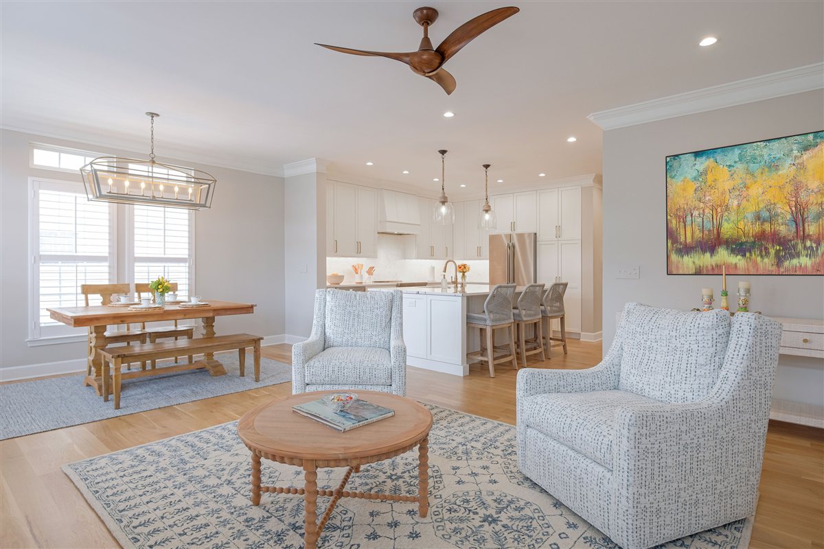 Open living and dining area with artwork and a ceiling fan, Peninsula townhouse renovation