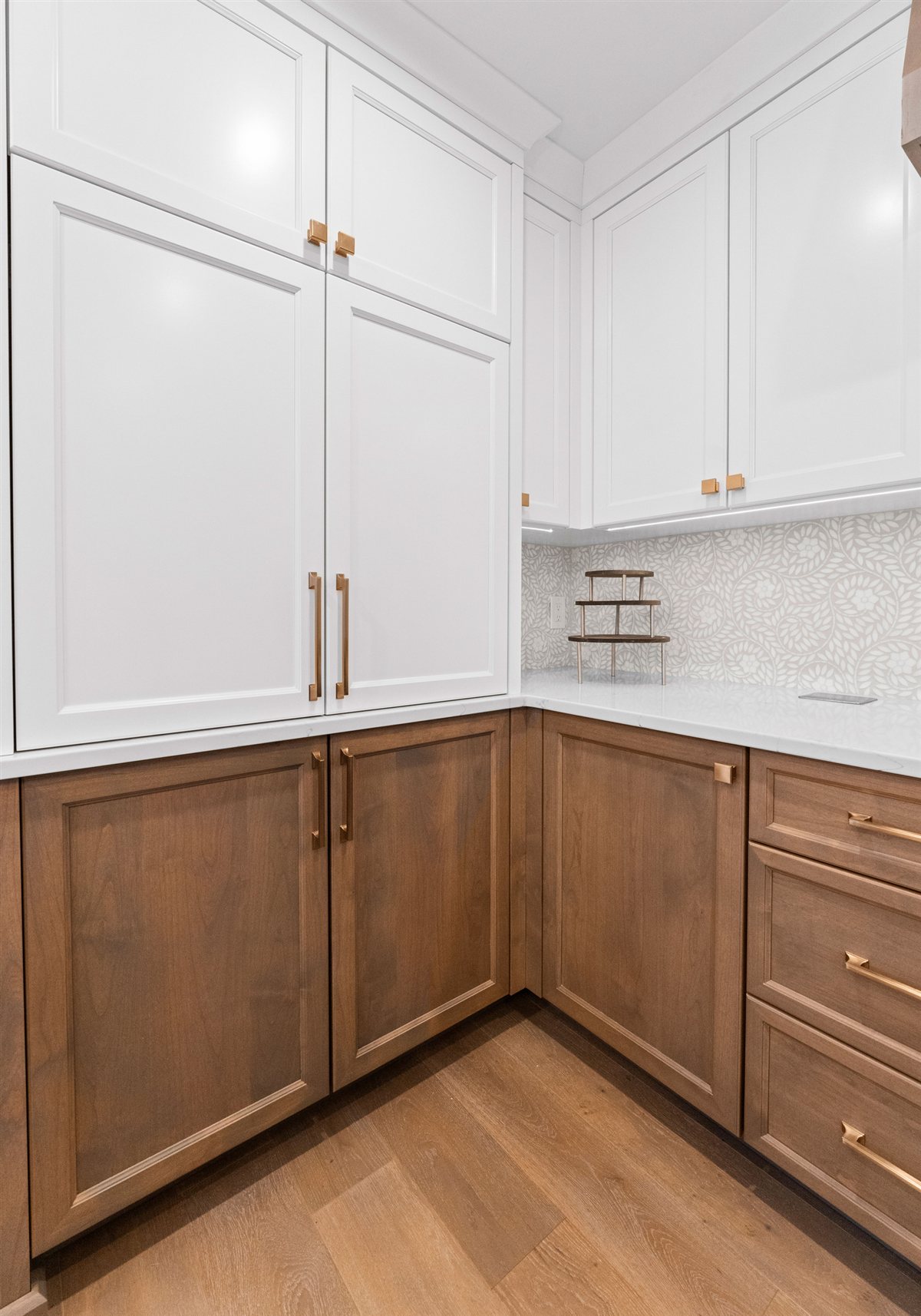 Wood corner cabinetry with white upper cabinets, River Chase kitchen