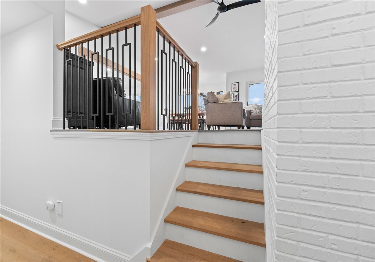 Stair and landing railing overlooking the living area, River Chase renovation