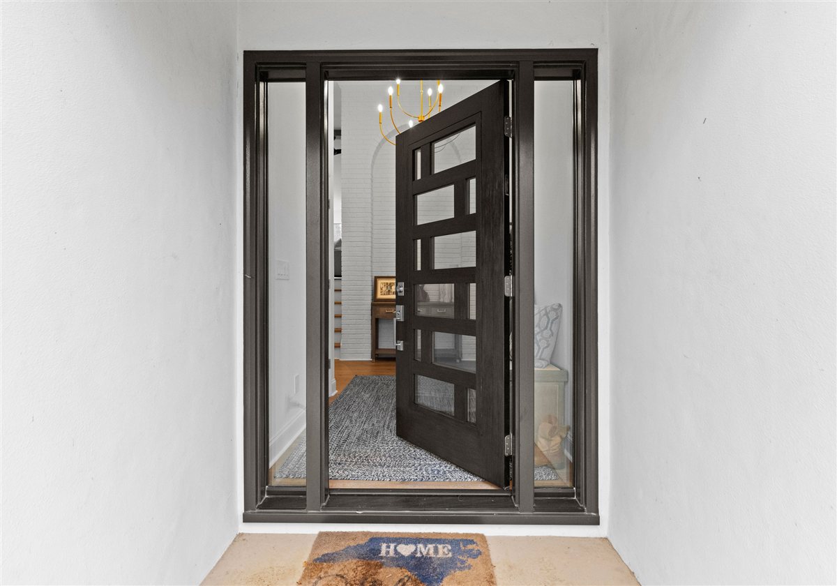 Front door with a dark frame and glass inserts, River Chase renovation