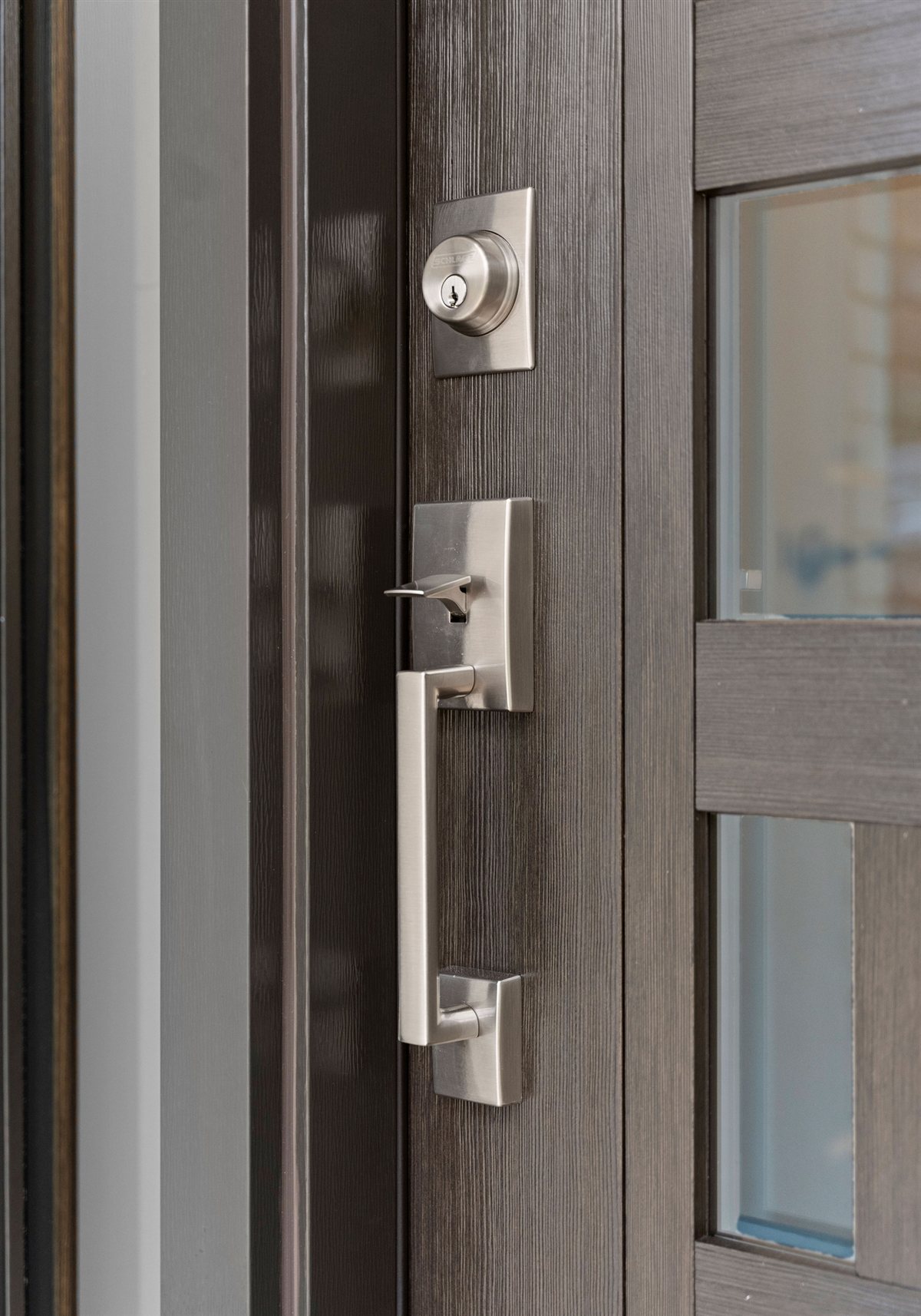 Dark door with a brushed nickel handle set, River Chase renovation