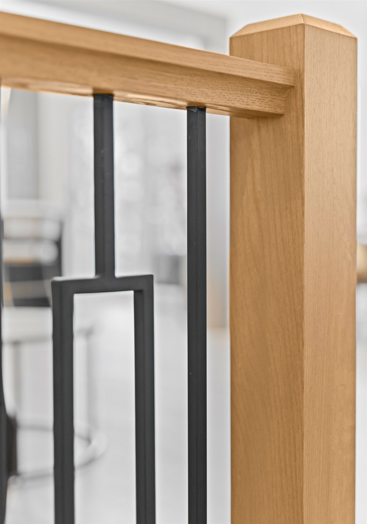 Oak newel post with black iron balusters, River Chase renovation