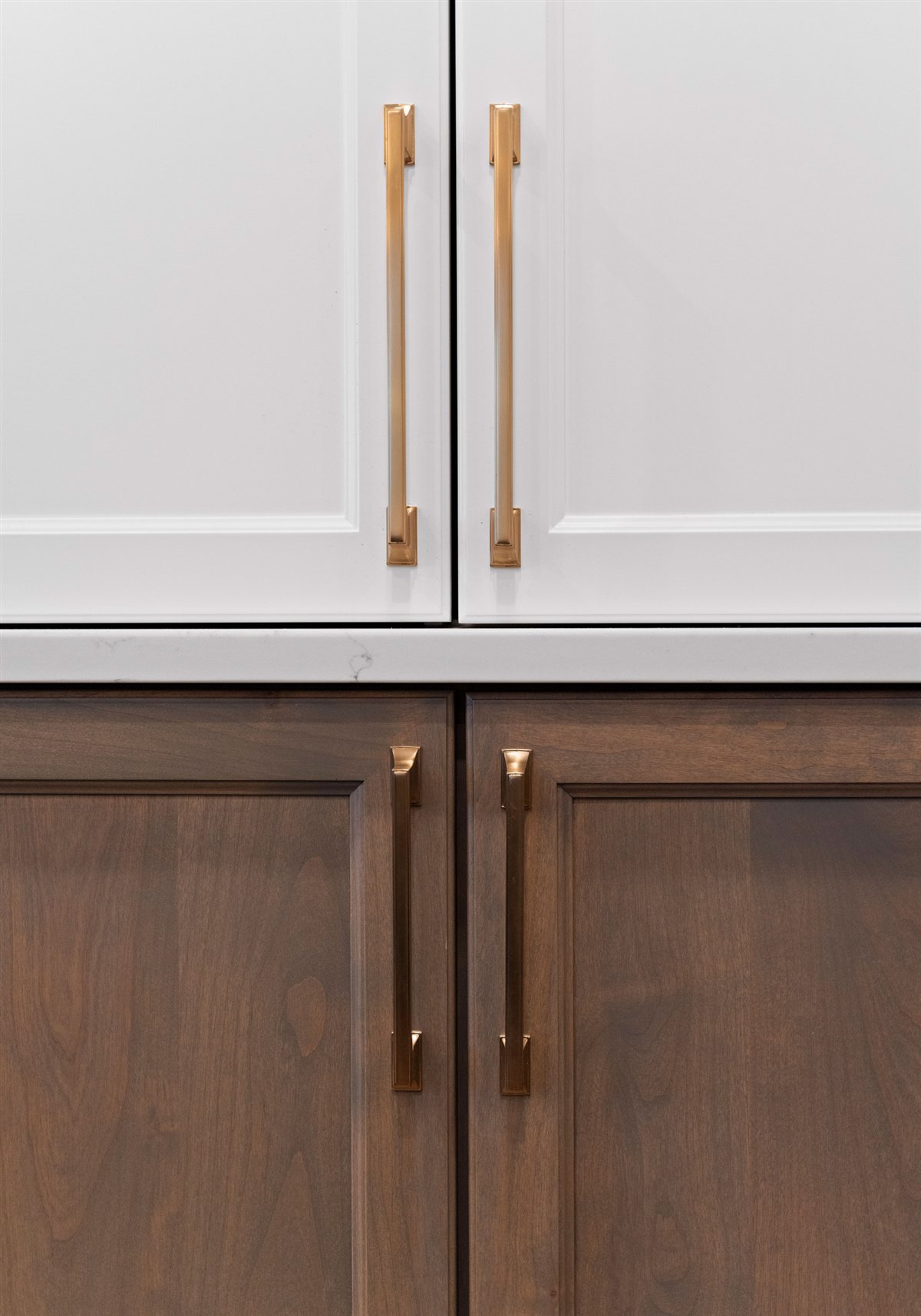 White upper and wood lower cabinets with brass pulls, River Chase kitchen