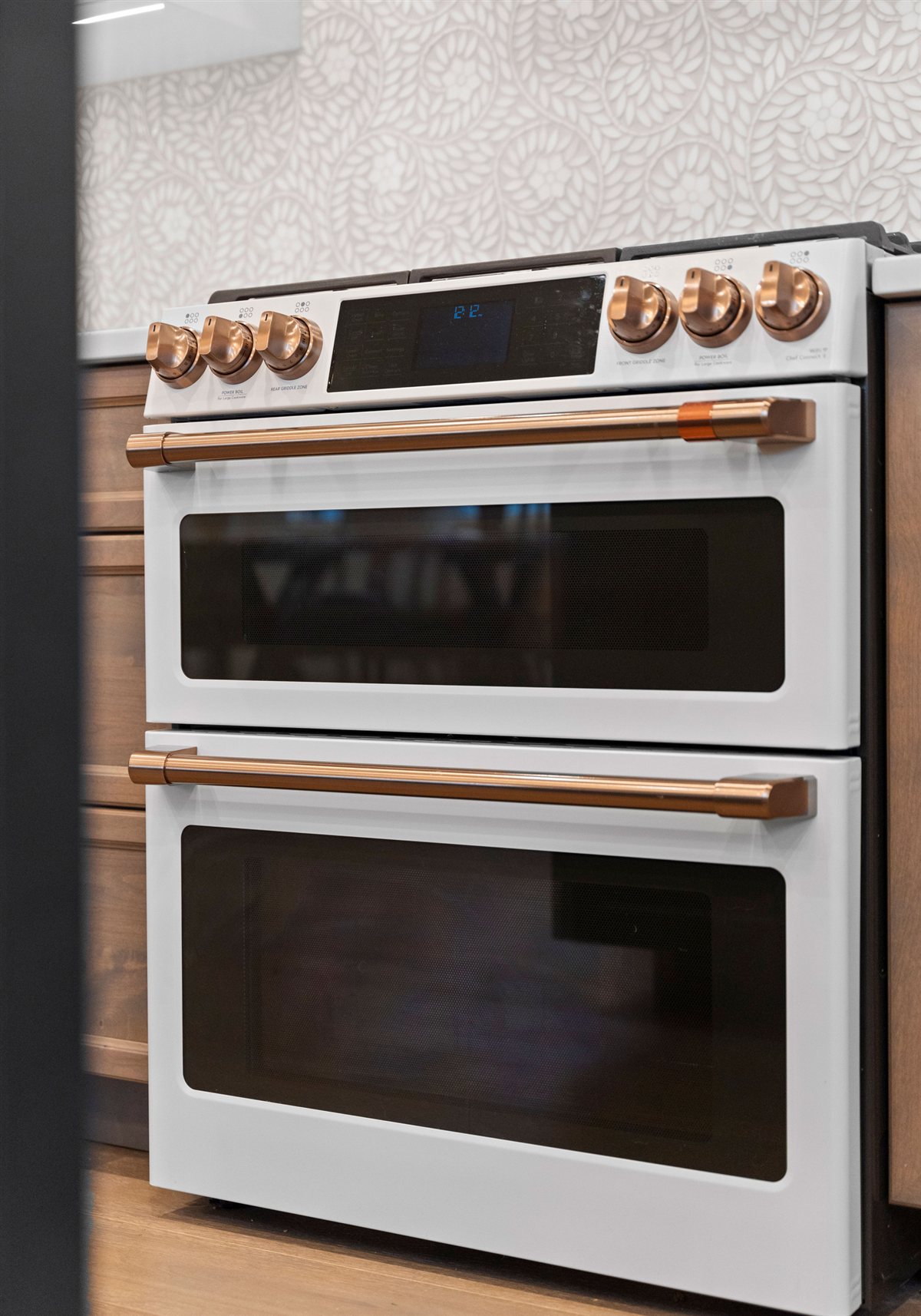 White double wall oven with copper handles, River Chase kitchen