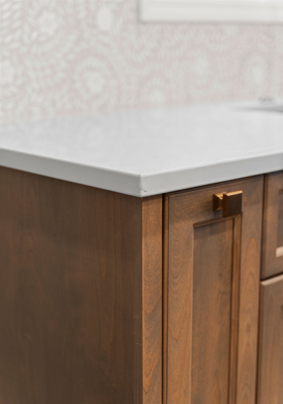 Wood cabinet end panel with a brass pull, River Chase kitchen