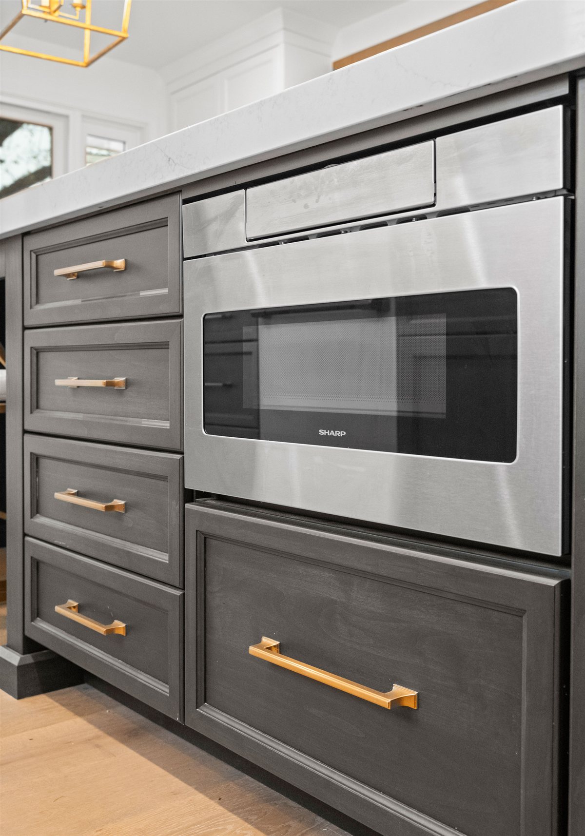 Dark island with a built-in microwave drawer, River Chase kitchen