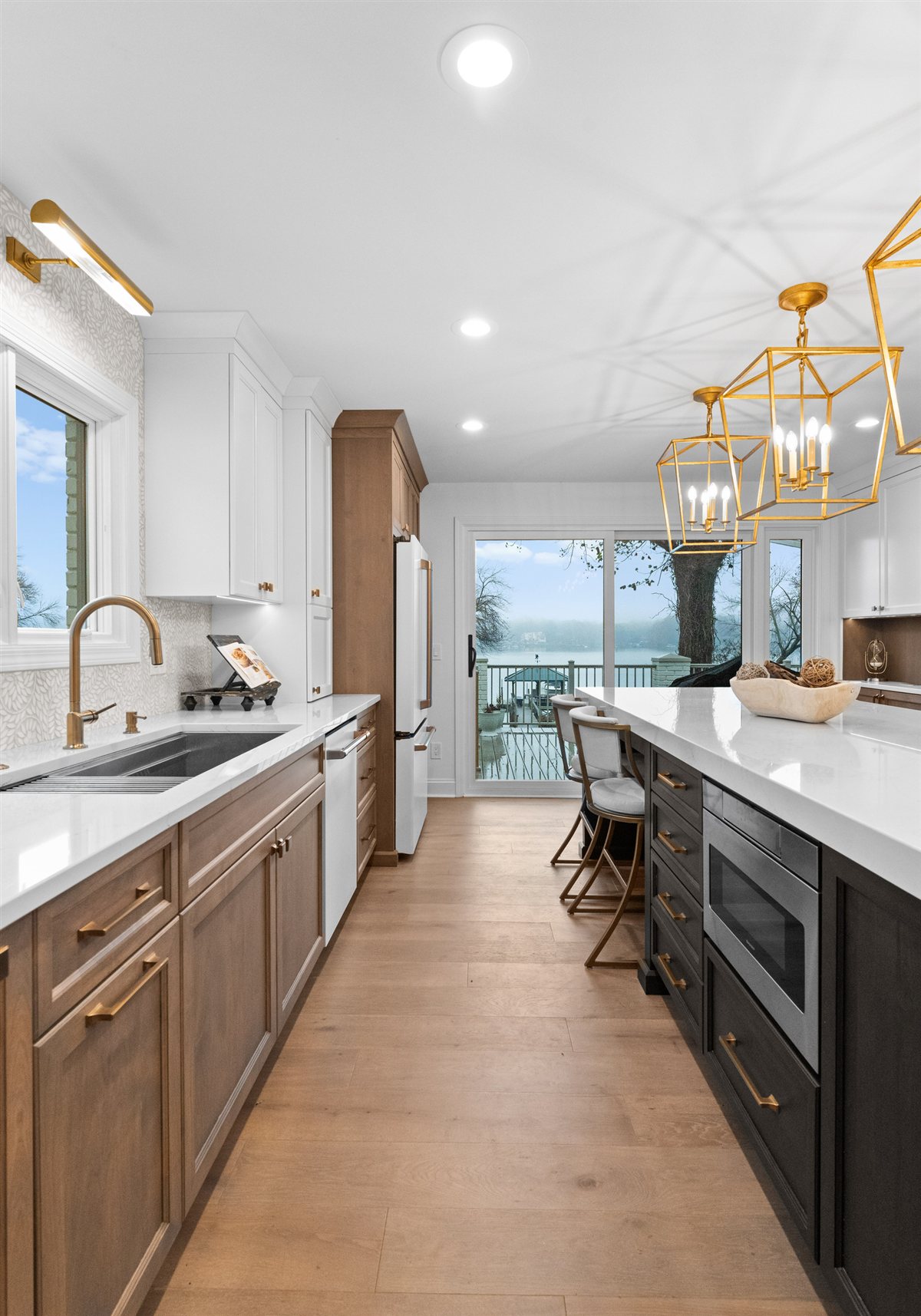 Long view down the kitchen toward lake-view windows, River Chase kitchen