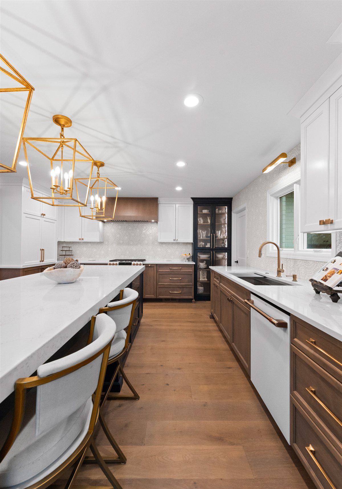 Kitchen run with island seating and brass pendants, River Chase renovation
