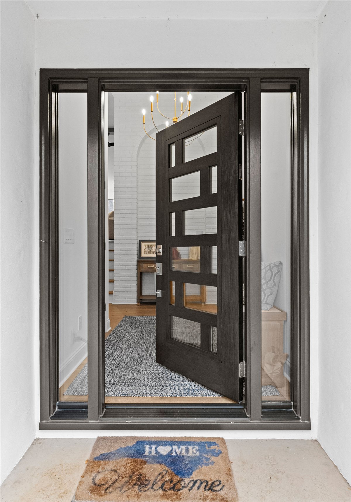Modern front door with glass panels, River Chase lakefront renovation