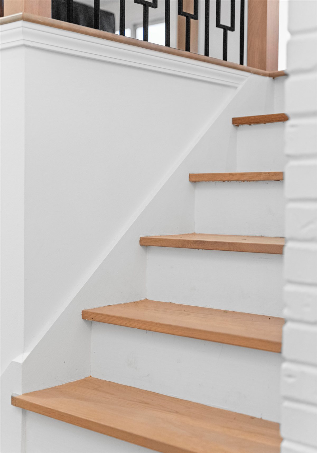 Stair with white risers and oak treads, River Chase renovation
