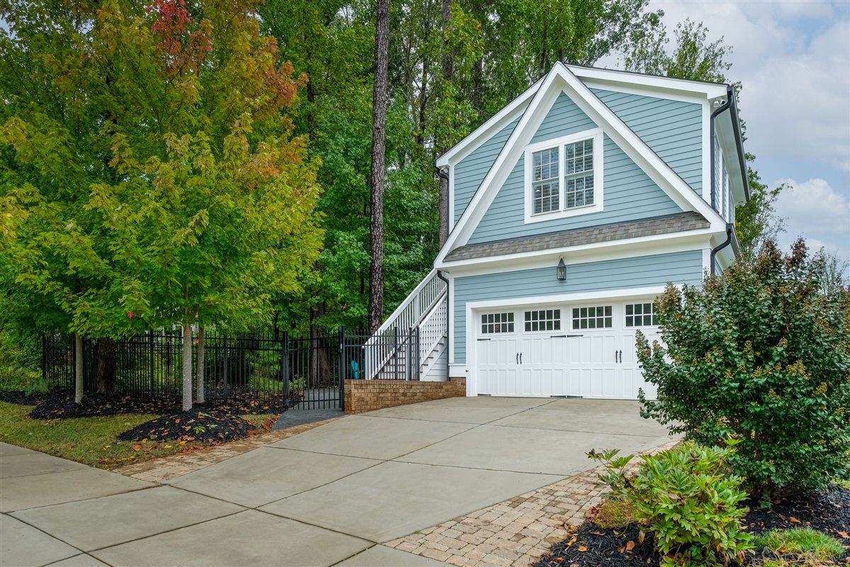 Detached garage with a guest suite above, blue siding and carriage doors, Davidson addition