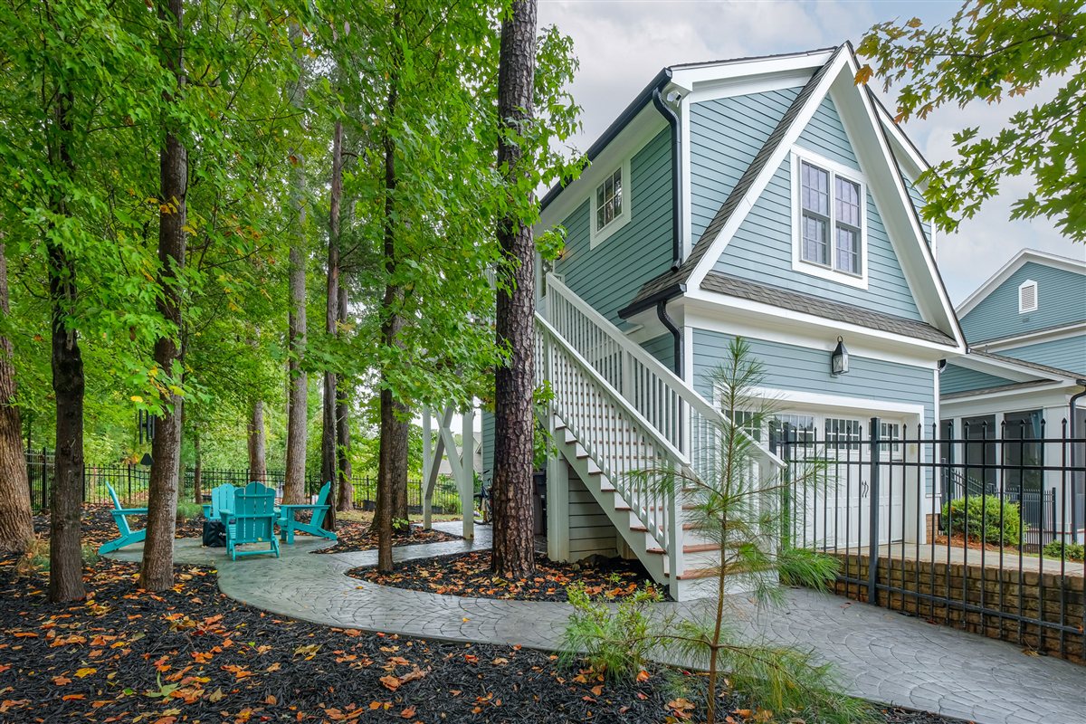 Garage guest suite with an exterior stair and fenced patio, Davidson addition