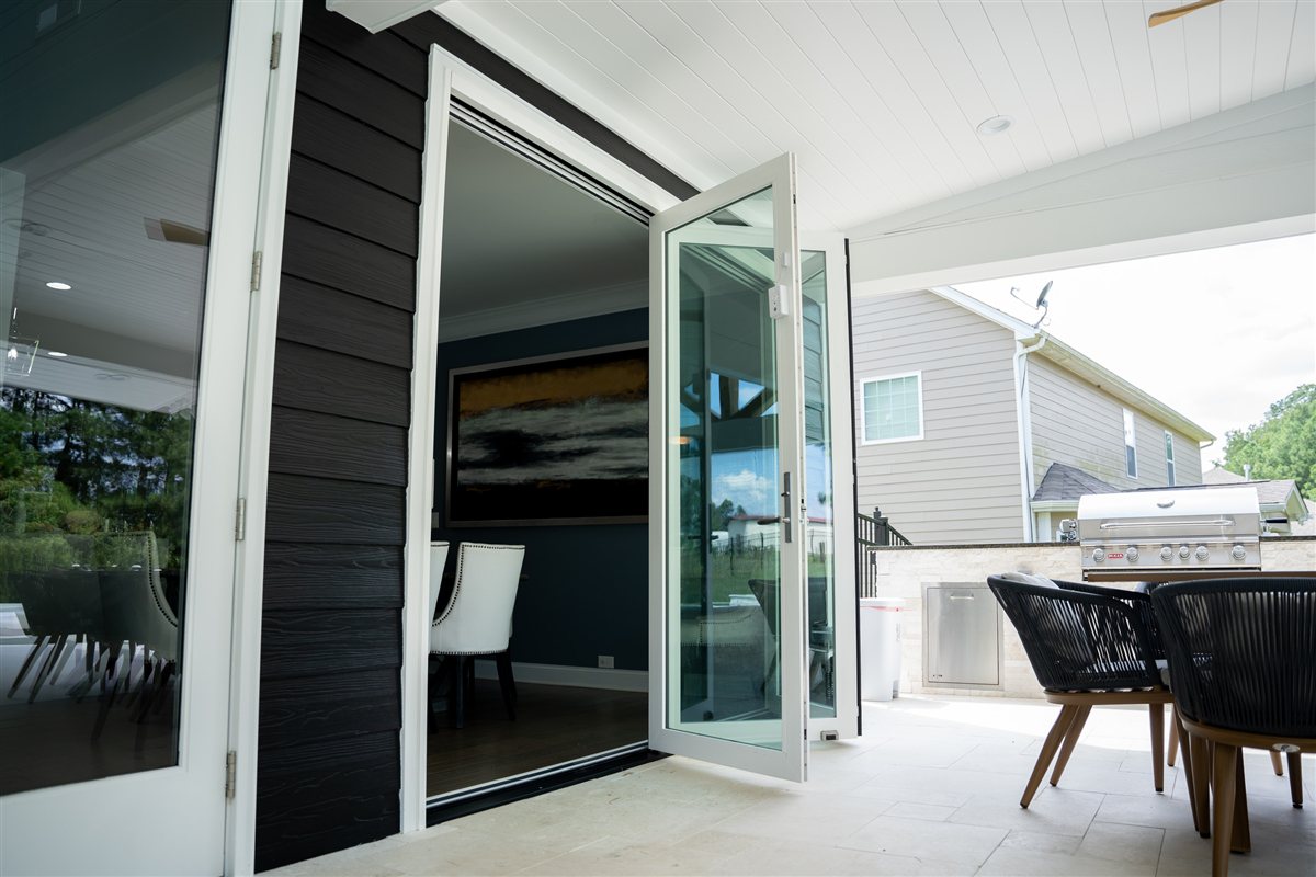 Covered patio with folding glass doors opening to the living room, Denver pool and outdoor living project