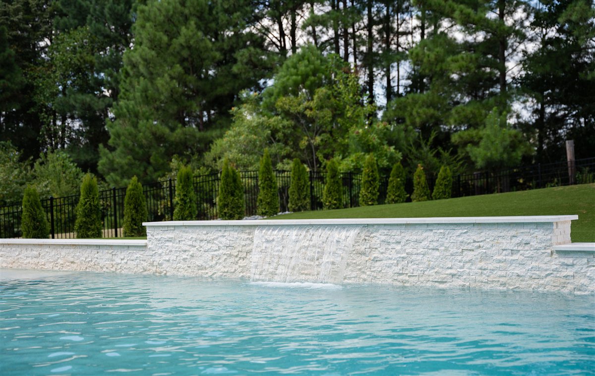 Pool with a stone water wall, Denver outdoor living