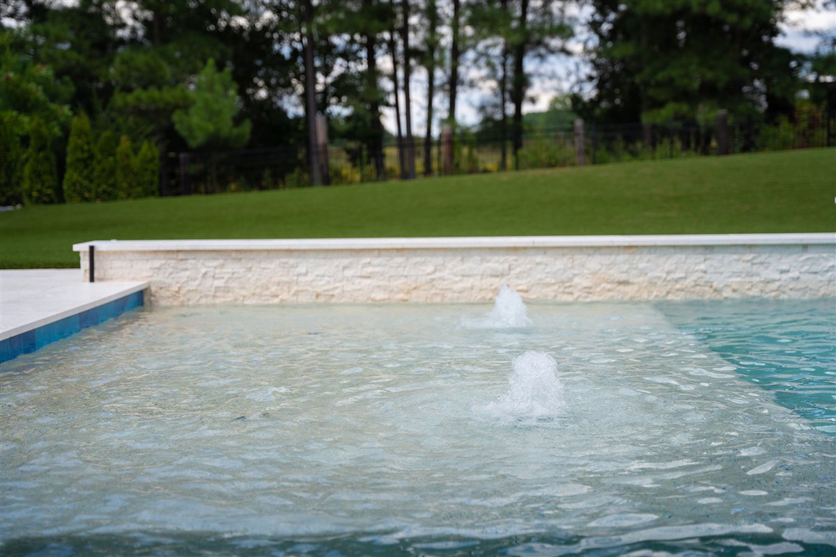 Pool fountains against a stone wall, Denver outdoor living