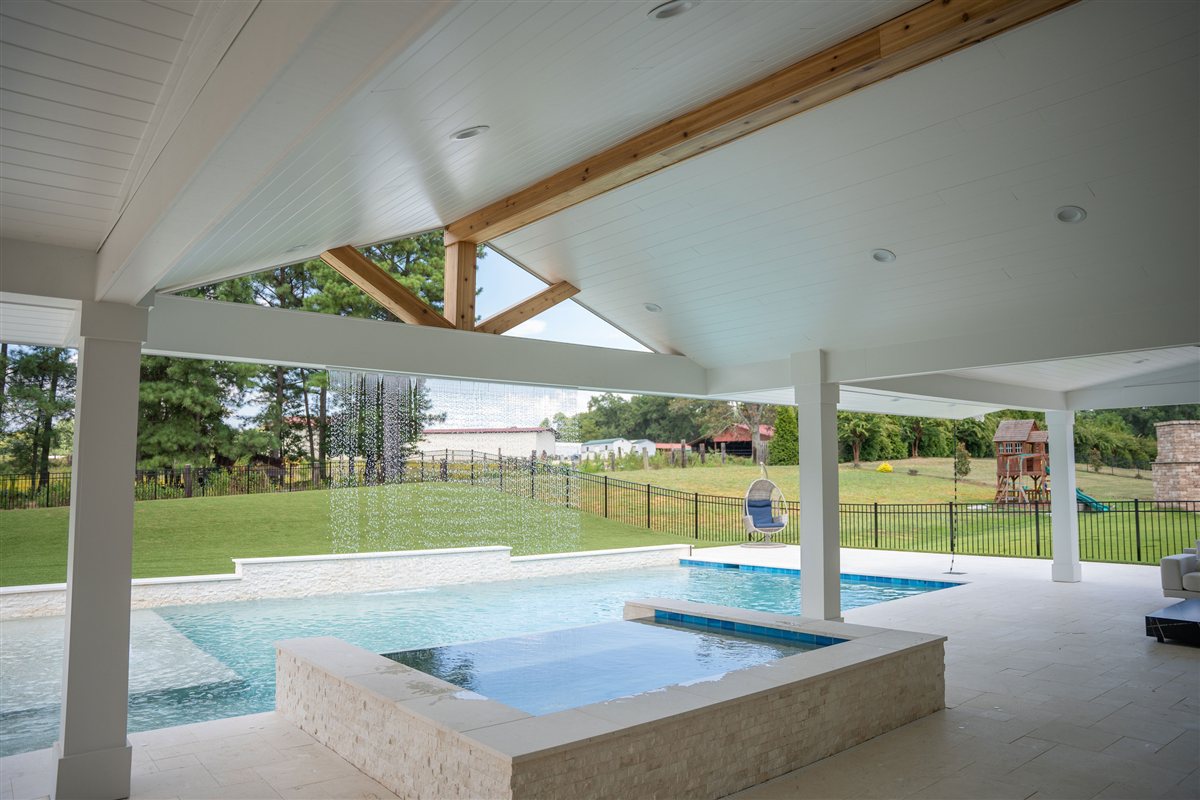 Covered porch beneath a vaulted ceiling with a raised spa beyond, Denver outdoor living