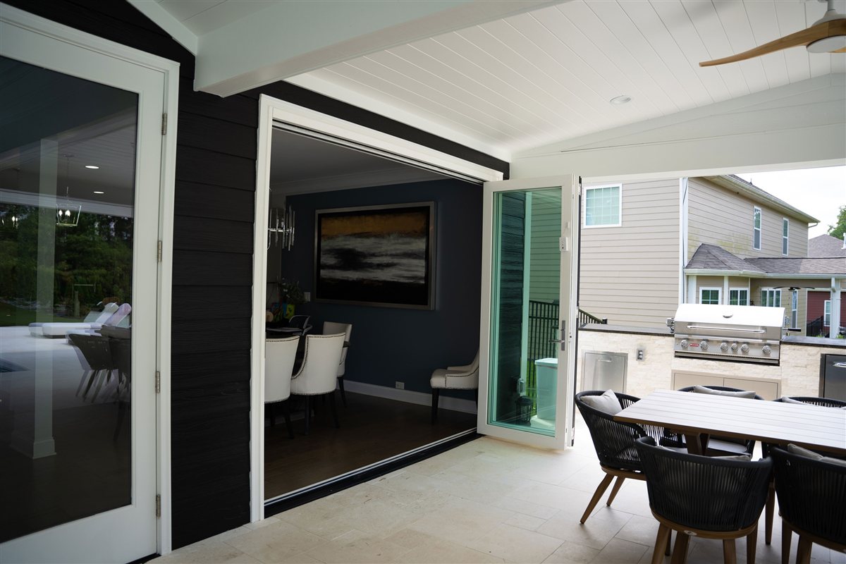 Folding glass doors open to the outdoor dining area, Denver outdoor living