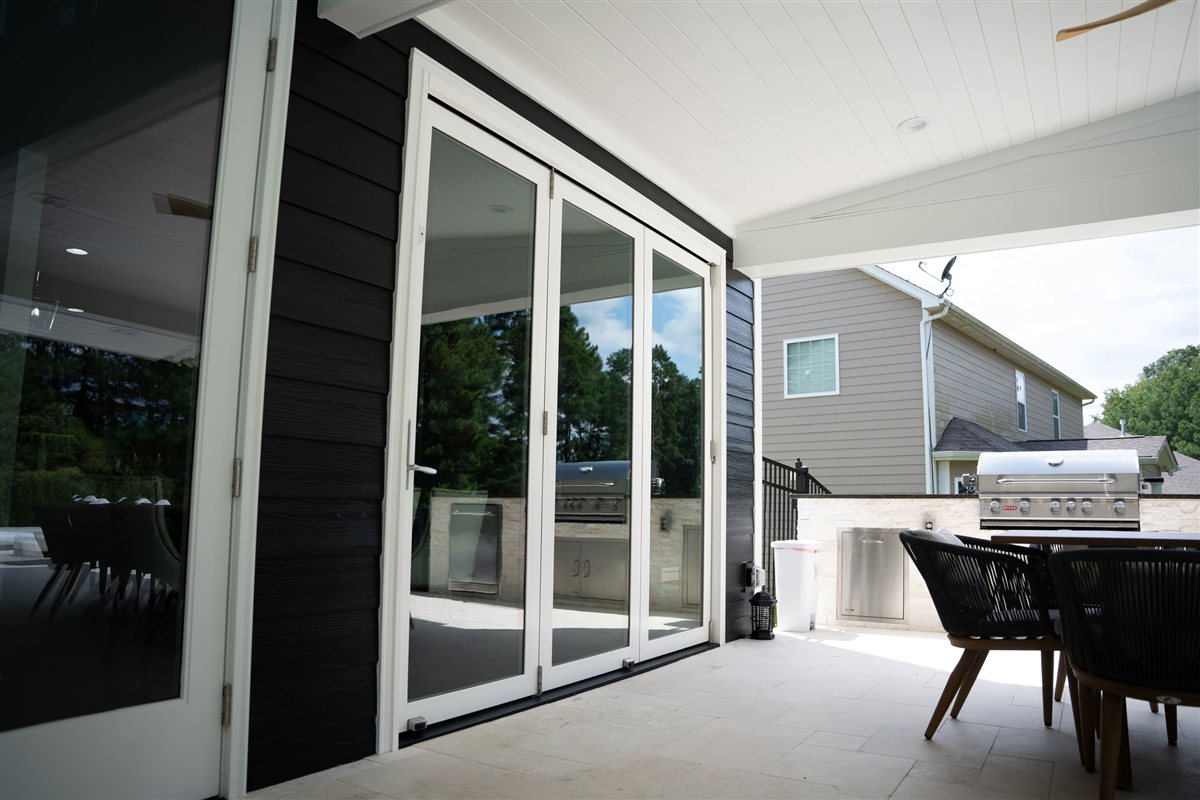 Glass doors and outdoor dining beneath the porch, Denver outdoor living