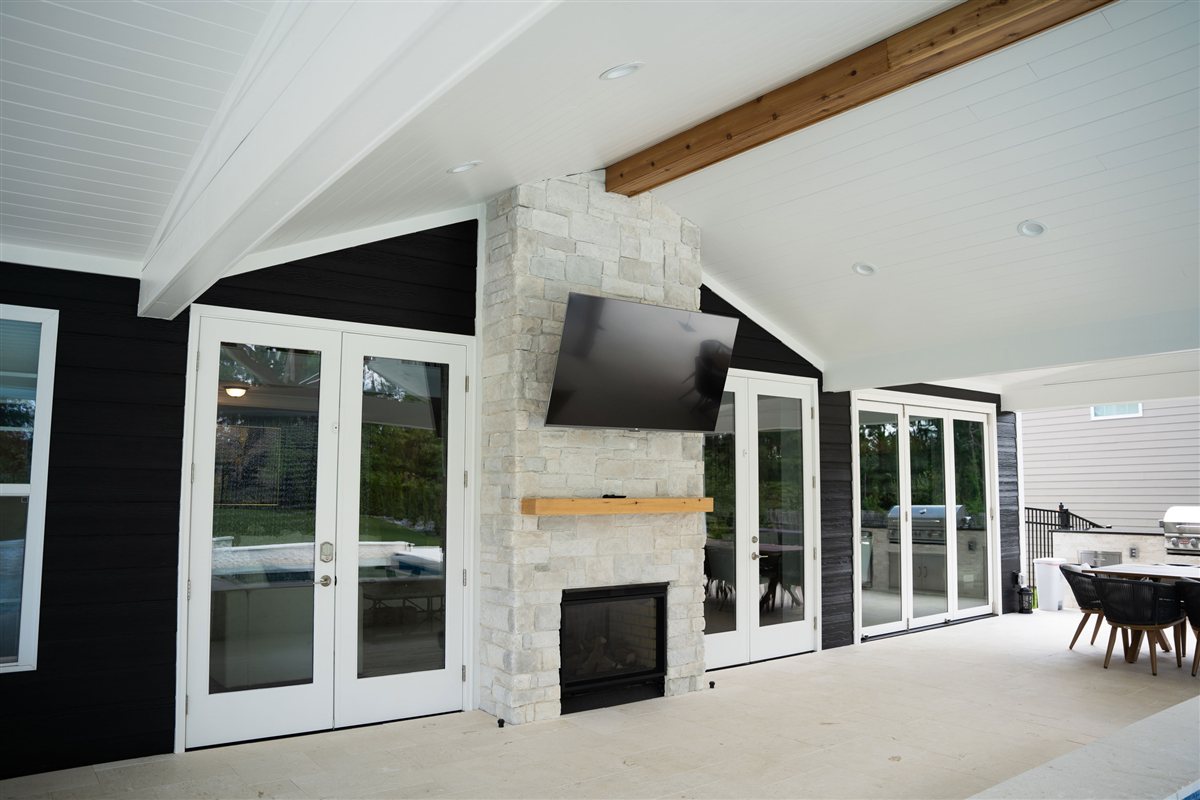 Stone fireplace wall with French doors on each side, Denver outdoor living