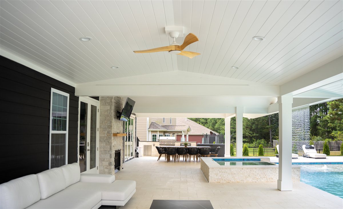 Covered porch seating with pool and spa beyond, Denver outdoor living