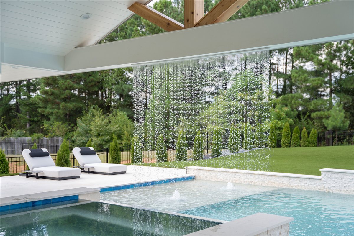 Pool and loungers seen through the rain curtain, Denver outdoor living