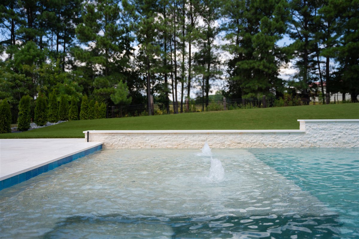 Pool with fountain jets along the back wall, Denver outdoor living