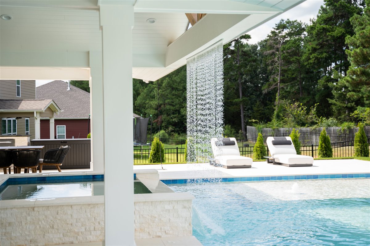 Rain curtain and pool seen from under the porch, Denver outdoor living